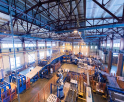 Fiberglass production industry equipment at manufacture background Factory workshop interior and machines on glass production background